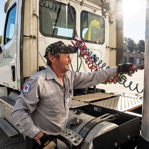 Picture of truck driver safely connecting trailer